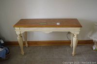 Front view of the solid wood hall table showing rectangular natural wood top and white painted fluted legs