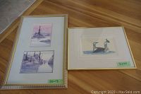 Two framed art prints placed on a wooden surface: one with two landscape prints by Graeme Shaw and the other with a loon print by David Poisey.