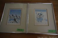 Photo showing two framed Inuit art prints side by side with labels 14x11
