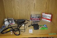 JBL subwoofer, three JBL SCS136 speakers, Pentax PC55 camera with case, US Robotics 56K USB modem box, CDs stacked.