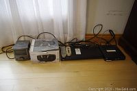 All electronic items in the lot shown on floor against wall including Bell 4100 TV box, JVC DVD player, Hipstreet AM/FM CD player, RCA clock radio.