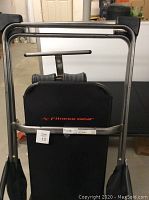 Front angled view of Fitness Gear inversion table showing padded black backrest with logo and sturdy metal frame