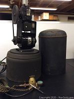 Full view of Bodine electric air compressor with mounted motor, belt, and cylindrical tank base.