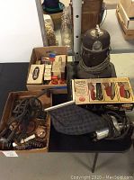 Vintage electric shoe polisher, multiple boxes of electrical switches, shoe polisher foot pedal and two vacuum cleaners.