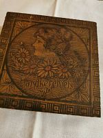 Top view of wooden handkerchief box with carved female figure and flowers on lid with the word 'Handkerchiefs'.