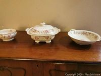 Three-piece Thomas Ivory floral dinnerware set: covered dish with lid and two bowls displayed on wooden surface.