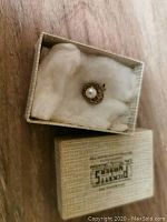 Pearl pendant in decorative textured box with white padding inside