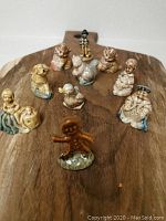 Front angle showing all 10 assorted Red Rose Wade ceramic figurines arranged on a wooden surface