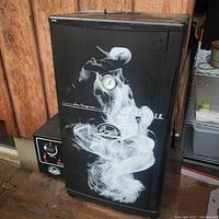 Black electric Bradley Smoker with temperature gauge and side-mounted smoke generator control unit