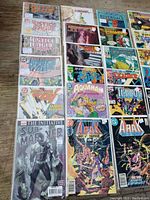 Photo of assorted comics including Justice League, Aquaman, Sub-Mariner, Arak Son of Thunder, Terror, and The Ray family reunion issues.