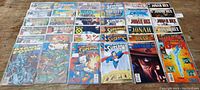 Lot of 28 comics including Superman, Jonah Hex, Wolverine, Sabrina and others fanned out for display.