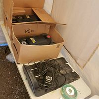 Two Cub Cadet XR2 1000 mowers in cardboard boxes on table