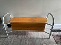 Side view showing the wooden seat and metal frame with curved armrests and backrest support.