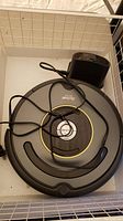 Top view of the Roomba robot vacuum and charging station showing overall condition