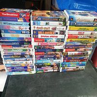 Photo showing the full stack of Disney and other VHS tapes capturing all visible titles and condition