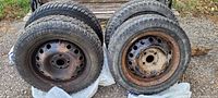 Four Winter Challenger winter tires 175/65 R14 mounted on steel rims with some rust. Tread pattern and tire markings visible.