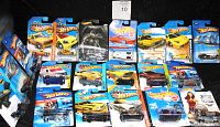 Photo showing 20 Hot Wheels cars in original mint on card packaging, variety of models and characters.