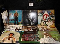 Photo showing front view of 12 assorted vintage vinyl albums including Elton John, Fleetwood Mac, Daryl Hall & John Oates among others.