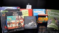 Photo showing the front covers of 12 assorted books including Wild Wild West, Babar books, Observing Nature, Left Behind, and others.
