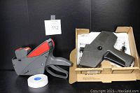 Two retail pricing label guns and rolls of labels shown with Monarch #1110 in box and Meto #1829 gun with labels roll