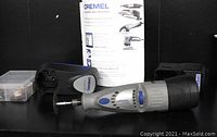 Dremel 7700 cordless rotary tool with battery pack, charger, manual, and accessories box