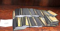 Photo showing multiple stacks of Magic The Gathering cards with backs facing up, displaying the card back art.