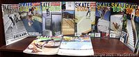Photo of all 10 Big Brother Skateboarding magazines standing upright, showing front covers with various skateboarding action shots and the 'Big Brother Skateboarding' logo.
