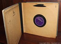 Open binder showing sleeved vintage 78 RPM record with purple Capitol Records label inside.