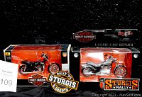 Two Maisto 1:18 scale die-cast Harley Davidson motorcycles in original boxes shown with two Sturgis Rally 1999 South Dakota patches.