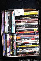Photo of the 40 DVD movies packed in a box, showing a diverse collection of titles including blockbusters and award-winning films. Some are 2-disc sets, and some DVDs are sealed or in widescreen format.