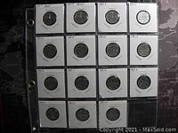 Fifteen 1951 Canadian 5 cent coins arranged in three rows encased in individual protective cardboard holders.