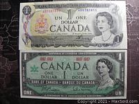 Front side of 1973 Canadian 1 dollar banknote and front side of 1967 Canadian centennial 1 dollar banknote