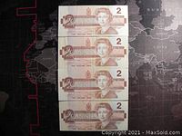 Front side of four 1986 Canadian $2 banknotes showing Queen Elizabeth II in brown hues, stacked vertically.