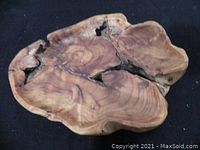 Top view of an irregular wooden bowl with natural voids and smooth grain patterns.
