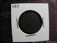 Back side of the 1884 Canadian large one cent coin showing wreath and denomination, in a white 2x2 holder.