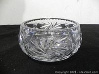 Side profile view showing round crystal bowl with intricate cut pinwheel and starburst patterns.