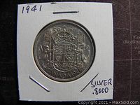 Reverse side of 1941 Canadian 50 cent silver coin showing the Canadian coat of arms and denomination noted on the holder.