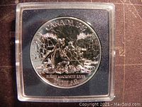 Reverse side of the coin showing the Fleet Mackenzie River scene and inscriptions, housed in a clear plastic case.