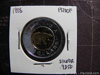 Reverse side showing polar bear and inscriptions on Canadian Twoonie silver coin.