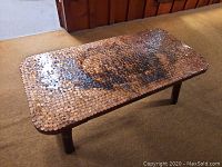 Top view of the rectangular coffee table showing the penny mosaic surface with lacquer finish and a mixed pattern of pennies.