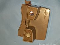 Top-down view of brown plastic View-Master stereo viewer showing front lever and eyepieces