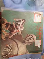 Vinyl album cover showing robot and Queen band members illustration