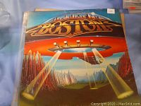 Front cover of the Boston vinyl record album showing distinctive colorful spaceship and cityscape album artwork with band name on top.