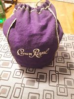 Closed purple Crown Royal bag showing gold embroidery and drawstring top.