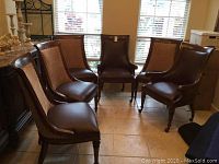 Six dining chairs arranged in semi-circle showing both captain’s chairs and side chairs