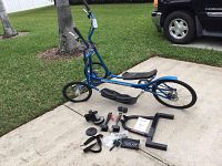 Full view of assembled StreetStrider elliptical bike on driveway.