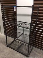 Front view of assembled Origami collapsible shelving unit showing all four wire shelves.