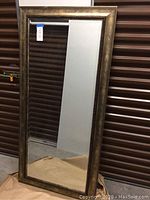 Full view of large framed mirror showing its size and frame detail