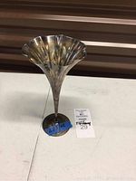 Front view of flute showing trumpet shape and scalloped rim