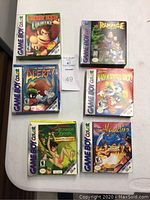 All six boxed Game Boy Color games arranged on table, showing front cover art of each original box.